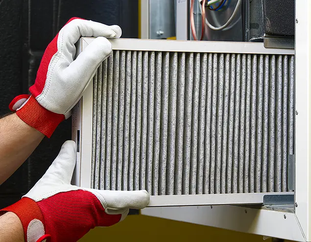 Technician installing a new air filter