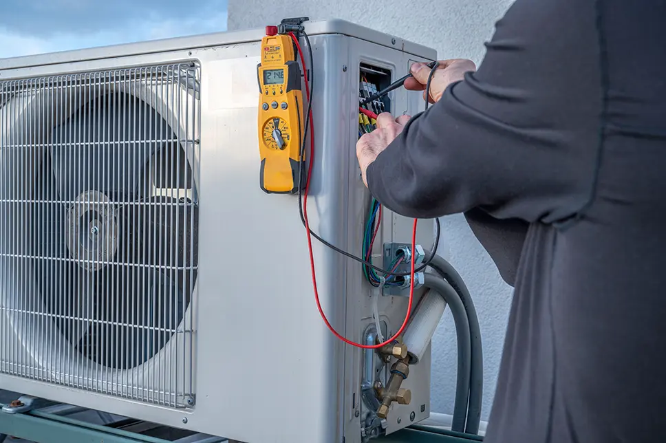 HVAC technician performing a mini-split system installation